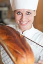 Smiling female chef baking bread Royalty Free Stock Photo