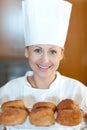 Smiling female chef baking scones