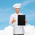 Smiling female chef with black blank paper Royalty Free Stock Photo