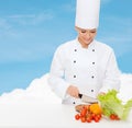 Smiling female chef chopping vegetables Royalty Free Stock Photo