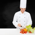 Smiling female chef chopping vegetables Royalty Free Stock Photo