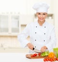 Smiling female chef chopping vegetables Royalty Free Stock Photo