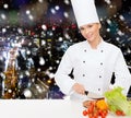 Smiling female chef chopping vegetables Royalty Free Stock Photo