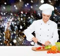 Smiling female chef chopping vegetables Royalty Free Stock Photo