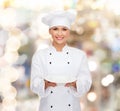 Smiling female chef with empty plate Royalty Free Stock Photo