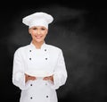 Smiling female chef with empty plate Royalty Free Stock Photo