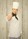 Smiling female chef giving thumbs up sign Royalty Free Stock Photo