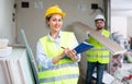 Smiling female civil engineer with documents at construction site Royalty Free Stock Photo