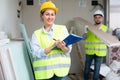 Smiling female civil engineer with documents at construction site Royalty Free Stock Photo