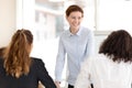 Smiling female coach stand holding work training with employees Royalty Free Stock Photo