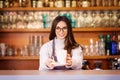 Smiling female coffee shop owner businesswoman standing behind the counter in the cafe Royalty Free Stock Photo