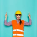 Smiling Female Construction Worker Pointing Up Royalty Free Stock Photo