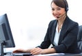 Smiling female customer support phone operator at workplace. Royalty Free Stock Photo