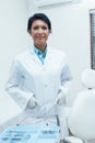 Smiling female dentist with hands in pockets Royalty Free Stock Photo