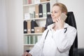 Smiling Female Doctor Calling on Mobile Phone Royalty Free Stock Photo