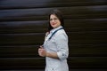 A young smiling female doctor in the eyes with a stethoscope looks at the camera. Royalty Free Stock Photo