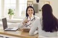 Smiling female doctor giving advice to young woman Royalty Free Stock Photo