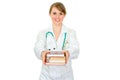 Smiling female doctor giving several books Royalty Free Stock Photo