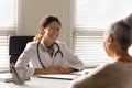 Smiling female doctor have meeting with old patient Royalty Free Stock Photo