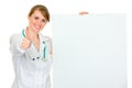 Smiling female doctor holding blank billboard Royalty Free Stock Photo