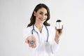 Smiling female doctor holding bottle of pills Royalty Free Stock Photo