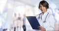 Smiling female doctor looking at camera and smiling while standing at hospital`s corridor Royalty Free Stock Photo