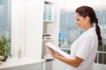 Smiling female doctor holding clipboard in medical office Royalty Free Stock Photo