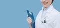 Smiling female doctor holding a clipboard Royalty Free Stock Photo