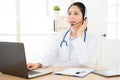 Smiling female doctor holding on the headphone Royalty Free Stock Photo