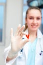 Smiling female doctor holding a heart in her hands. The concept of medetsine, saving lives. Heart as a symbol of life