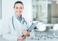 Smiling female doctor holding medical records Royalty Free Stock Photo