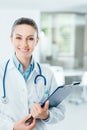 Smiling female doctor holding medical records Royalty Free Stock Photo