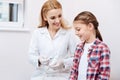 Smiling female doctor holding syringe