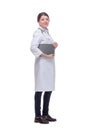 Smiling female doctor with lab coat in her office holding a clipboard with medical records Royalty Free Stock Photo