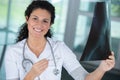 smiling female doctor looking at x-ray Royalty Free Stock Photo