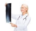 Smiling female doctor looking at x-ray Royalty Free Stock Photo