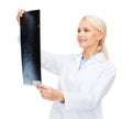 Smiling female doctor looking at x-ray Royalty Free Stock Photo