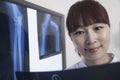 Smiling female doctor looking at x-ray of human bones Royalty Free Stock Photo