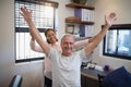 Smiling female doctor and male patient with arms raised Royalty Free Stock Photo