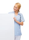 Smiling female doctor or nurse with blank board Royalty Free Stock Photo