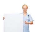 Smiling female doctor or nurse with blank board Royalty Free Stock Photo