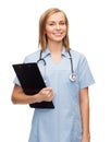 Smiling female doctor or nurse with clipboard Royalty Free Stock Photo