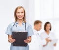 Smiling female doctor or nurse with clipboard Royalty Free Stock Photo