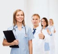 Smiling female doctor or nurse with clipboard Royalty Free Stock Photo