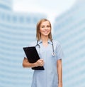 Smiling female doctor or nurse with clipboard Royalty Free Stock Photo