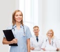 Smiling female doctor or nurse with clipboard Royalty Free Stock Photo