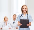 Smiling female doctor or nurse with clipboard Royalty Free Stock Photo