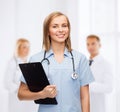 Smiling female doctor or nurse with clipboard Royalty Free Stock Photo