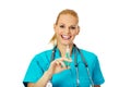 Smiling female doctor or nurse with stethoscope holding syringe Royalty Free Stock Photo