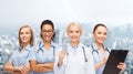 Smiling female doctor and nurses with stethoscope